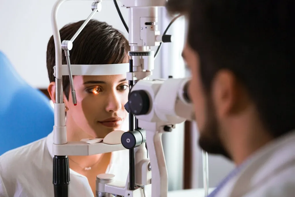 Optometrist checking patient's eyesight.